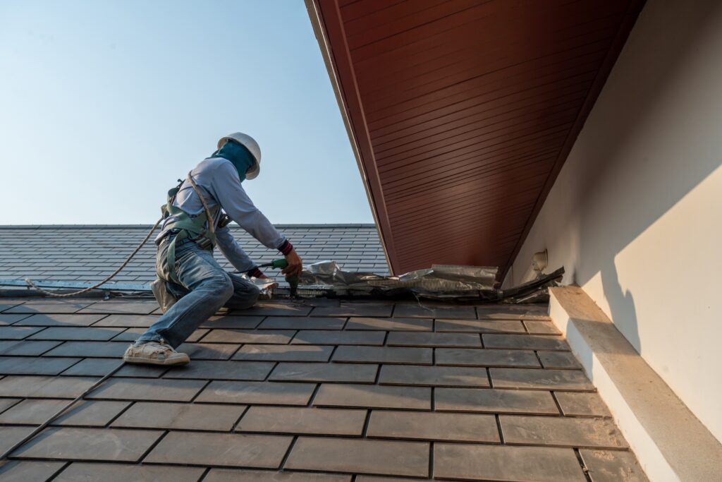 A roofing professional on a roof working