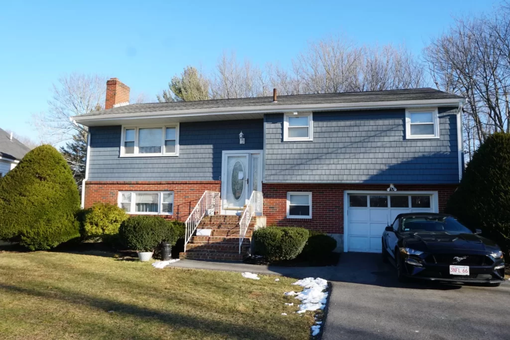 new blue shingle siding on split level house