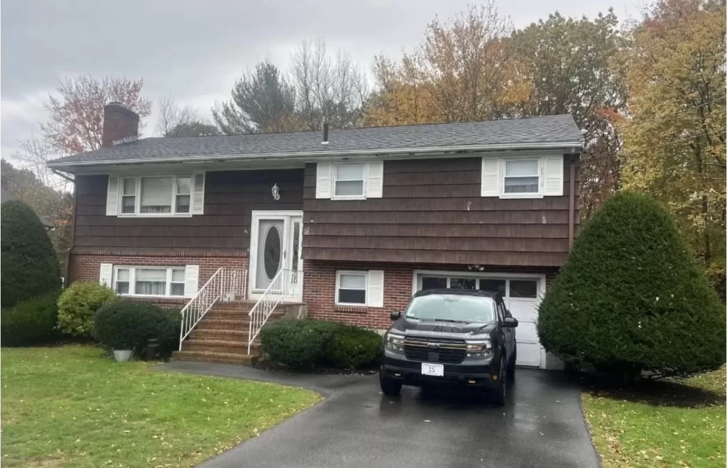 old brown painted cedar siding on split level house
