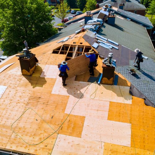 roofing team installing wood panels on roof
